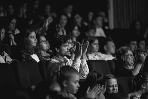 black and white shot of audience clapping