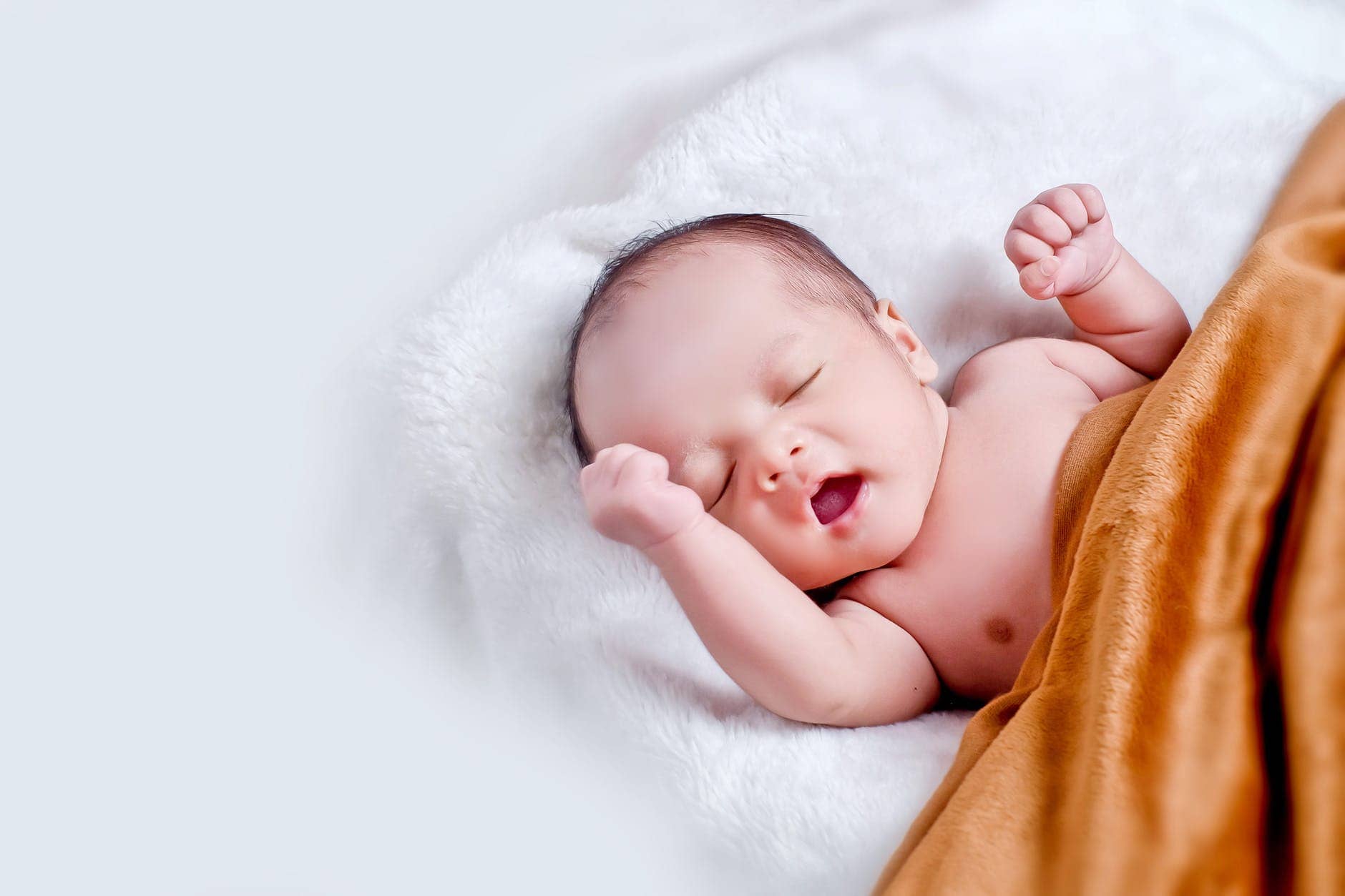 The way things stood - baby lying on white fur with brown blanket