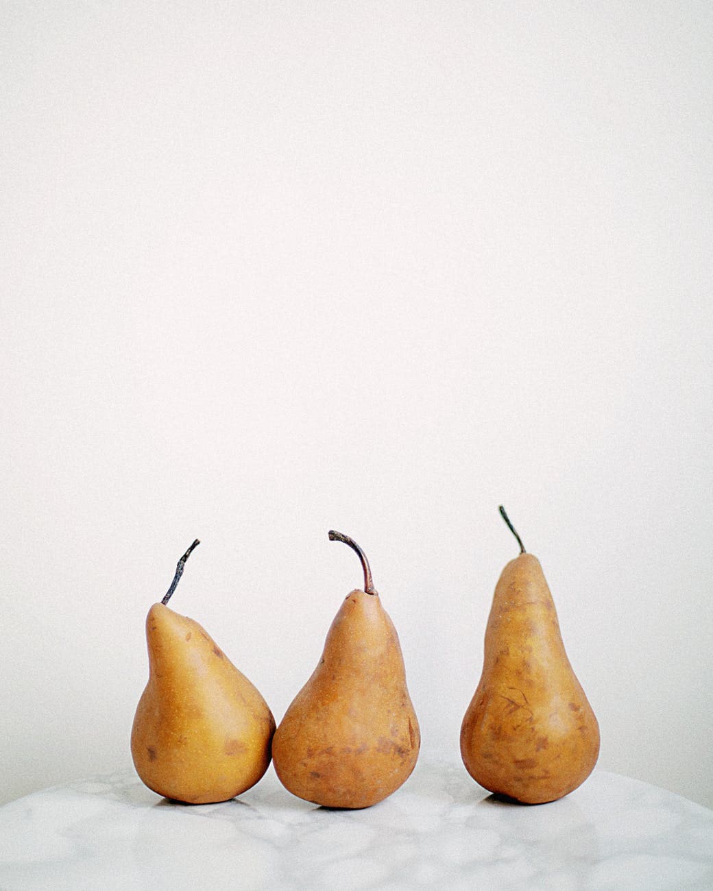 Like Jake and Me - pears - three brown fruits on white textile