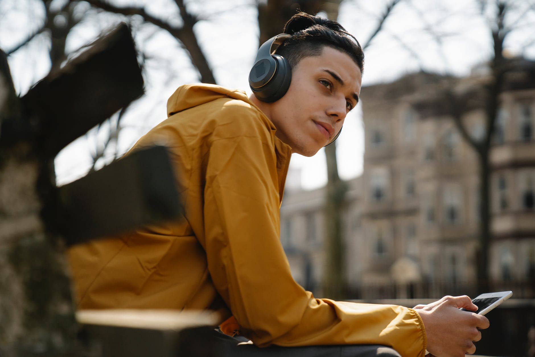 teen boy with headphones using mobile phone