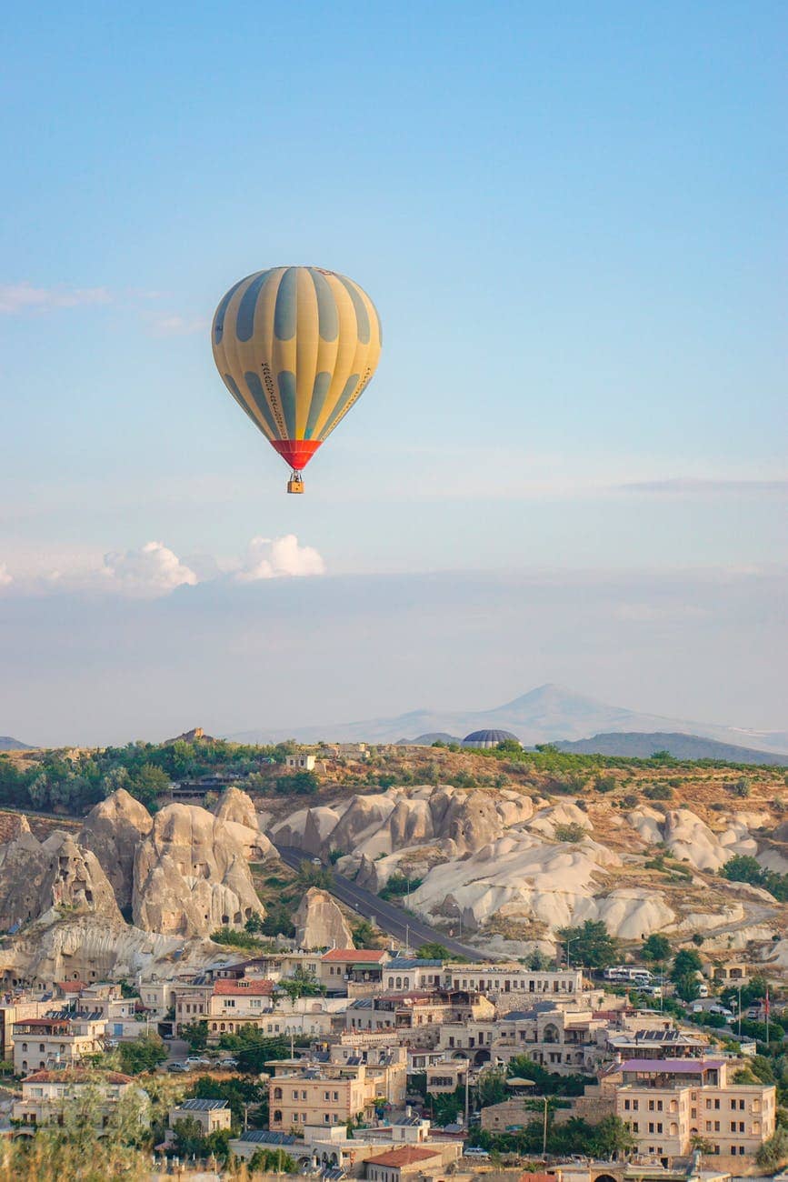 hot air balloon flying over the city